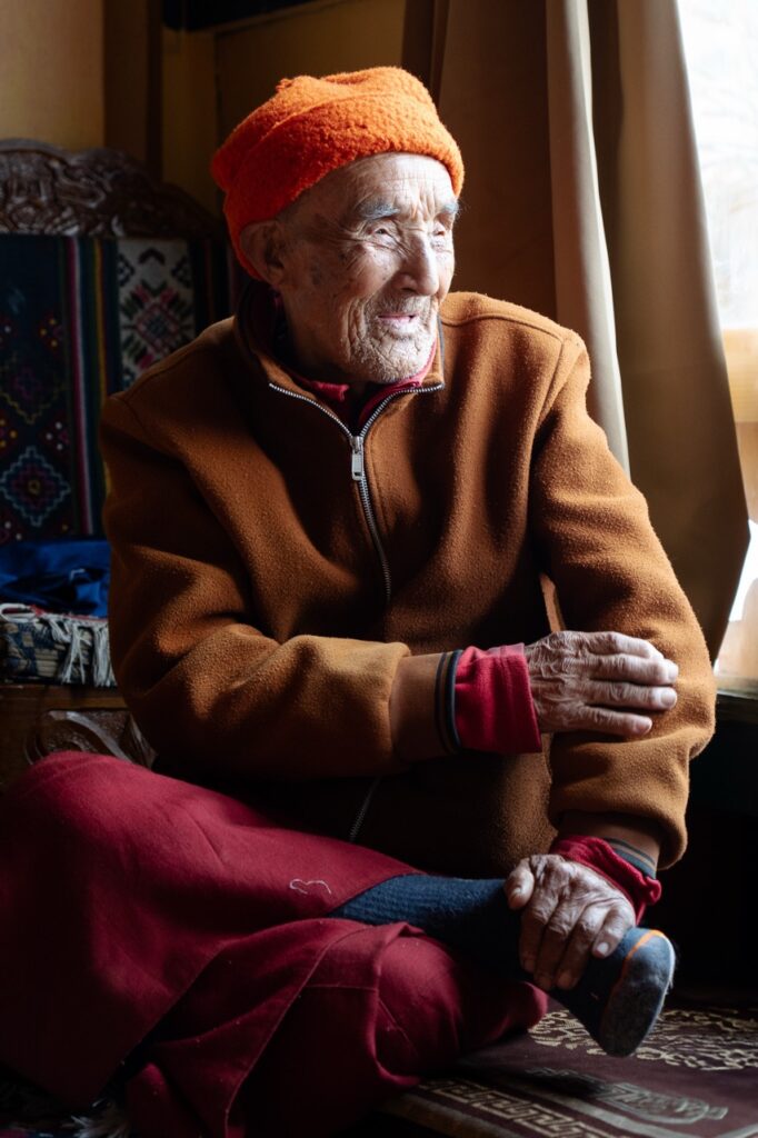 Abuelo butanés en el salón de su casa rural o farmhouses donde familias alojan a turistas y visitantes en Bután (Bhutan)